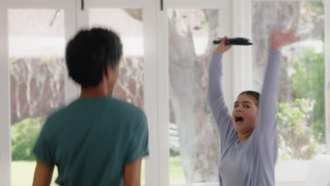 happy father dancing with teenage daughter having fun enjoying playful dance enjoying weekend celebration at home wearing pajamas