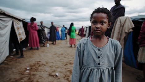 portrait of a young girl in a displacement camp