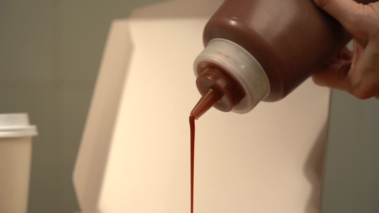 adding topping milk caramel candy sweet to waffles and coffee slow motion