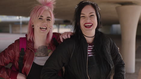 happy-portrait-of-two-authentic-woman-friends-wearing-alternative-grunge-fashion-smiling-cheerful-posing-at-camera