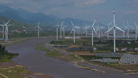 drone footage of large electric windmill in a flat basin