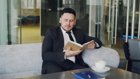 businessman reading in a cafe
