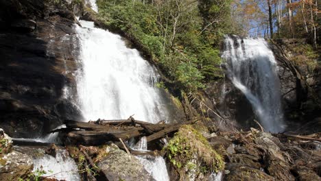 water cascades down anna ruby falls on autumn day, wide, slow motion