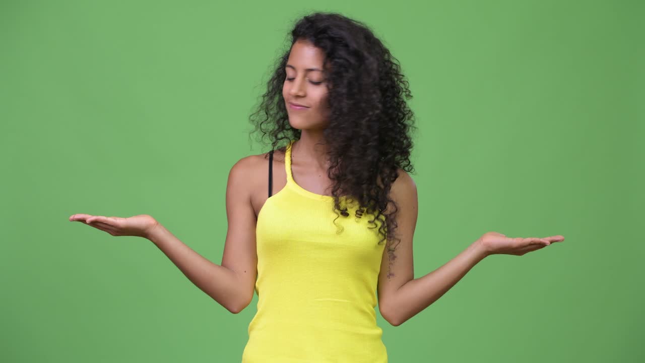 Young beautiful Hispanic woman choosing between left and right