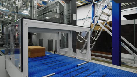 boxes being sealed and labeled by automated machinery in packaging warehouse