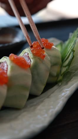 delicious cucumber rolls with salmon and caviar