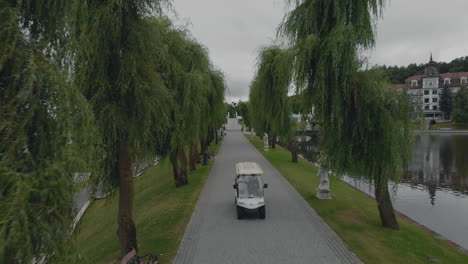 park pathway with golf cart and water feature