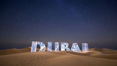 dubai desert at night with illuminated sign