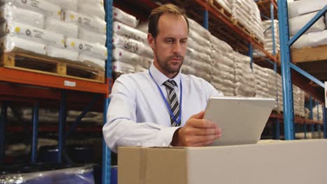 male manager using tablet in warehouse 4k