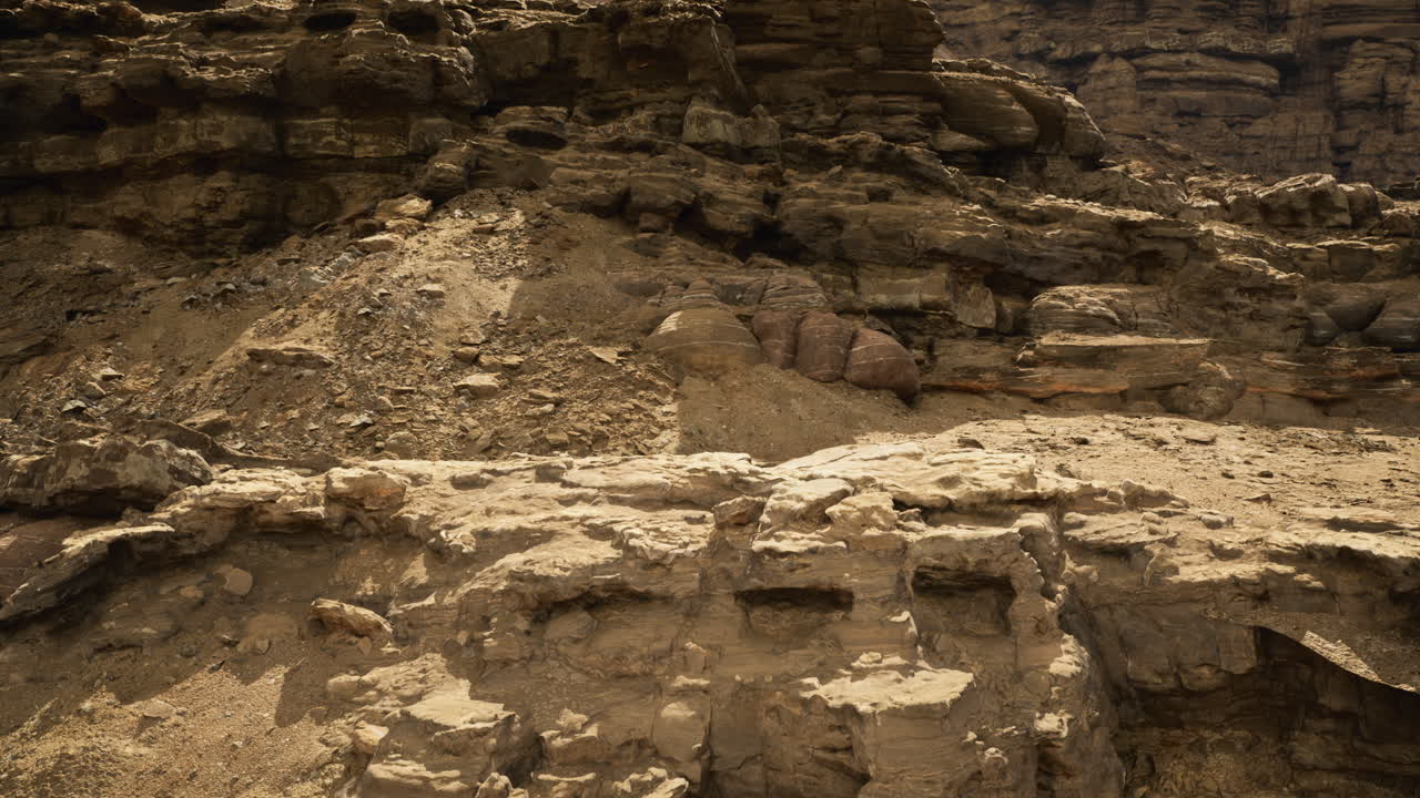 Eroded rocky terrain in a sunlit desert landscape