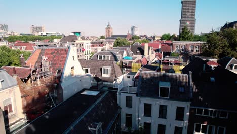 aerial drone tilt up shot over residential houses along the city center of utrecht in the netherlands on a sunny day