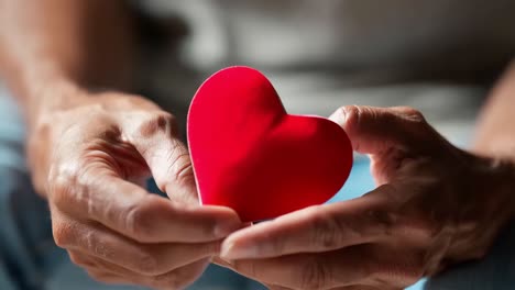 man holding a red heart