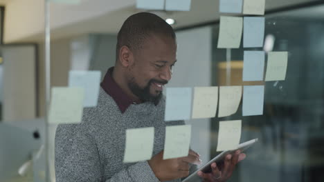 4k footage of a smiling mature businessman writing