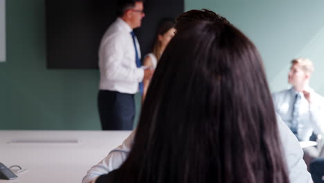 Group-Collaborating-On-Task-At-Graduate-Recruitment-Assessment-Day-Whilst-Being-Observed-By-Recruitment-Team