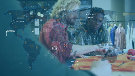 animation of world map and data processing over diverse male designers at fashion studio