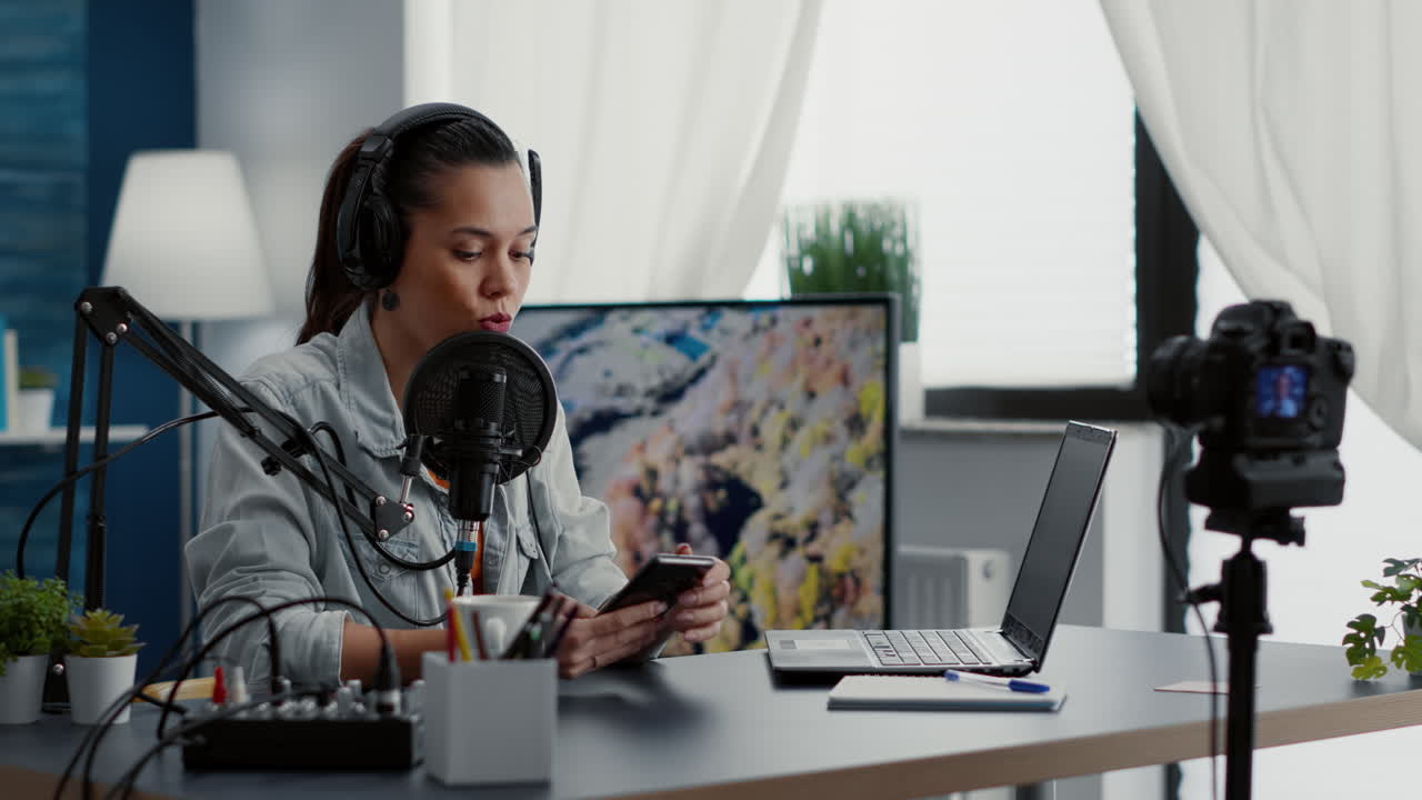 Famous social media influencer answering audience questions on smartphone while filming vlog