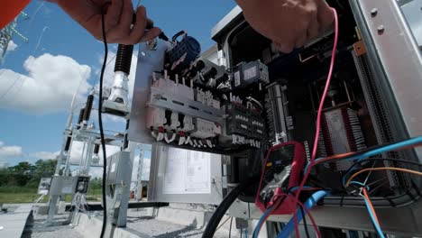 electrical engineers inspect the electrical systems at the equipment control cabinet