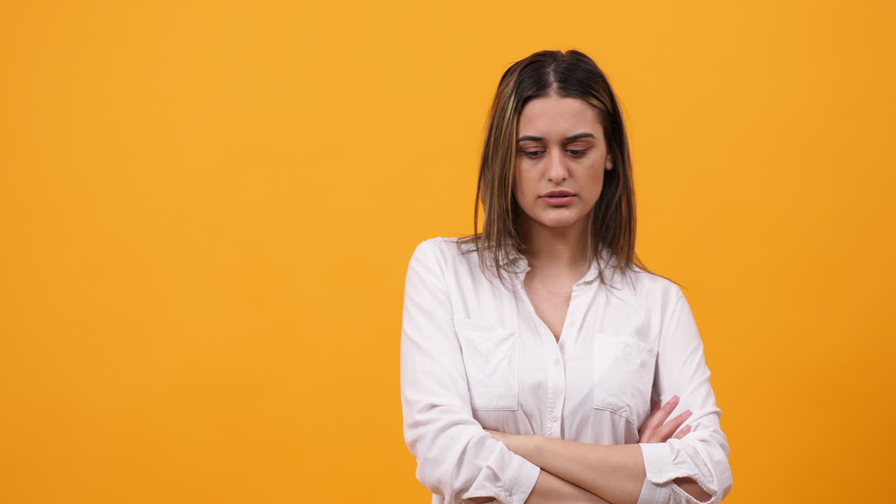 Woman expressing boredom and frustration on yellow background