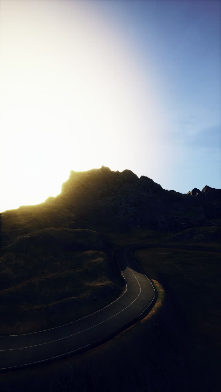 Bright sunlight on winding coastal road