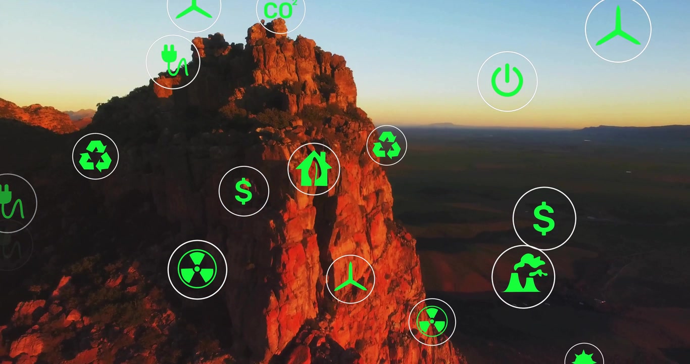 Aerial view starting energy icons floating over rock face panning up showcasing sustainability
