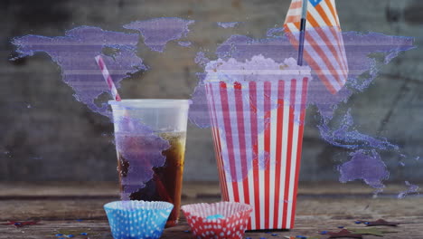 popcorn and soda with straws over world map animation