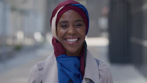 portrait happy african american business woman smiling in city urban scene