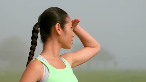 Smiling-sporty-woman-looking-away