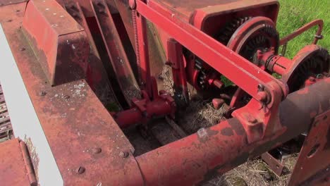 a view from above of the fingers in motion on a baler for small square bales