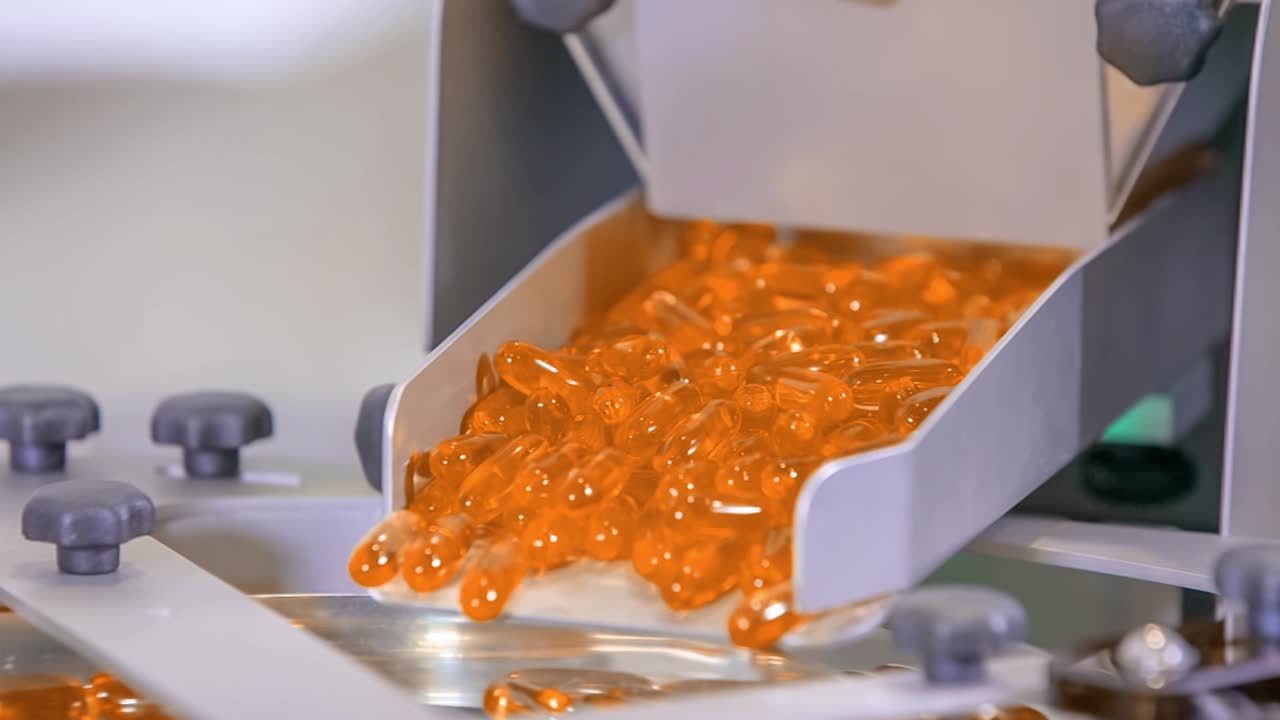 Close-up of drug, orange gel pills, for Coronavirus treatment in mass production