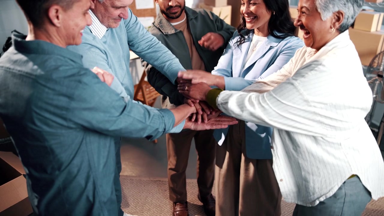 Diverse Business Team Stacking Hands in Office