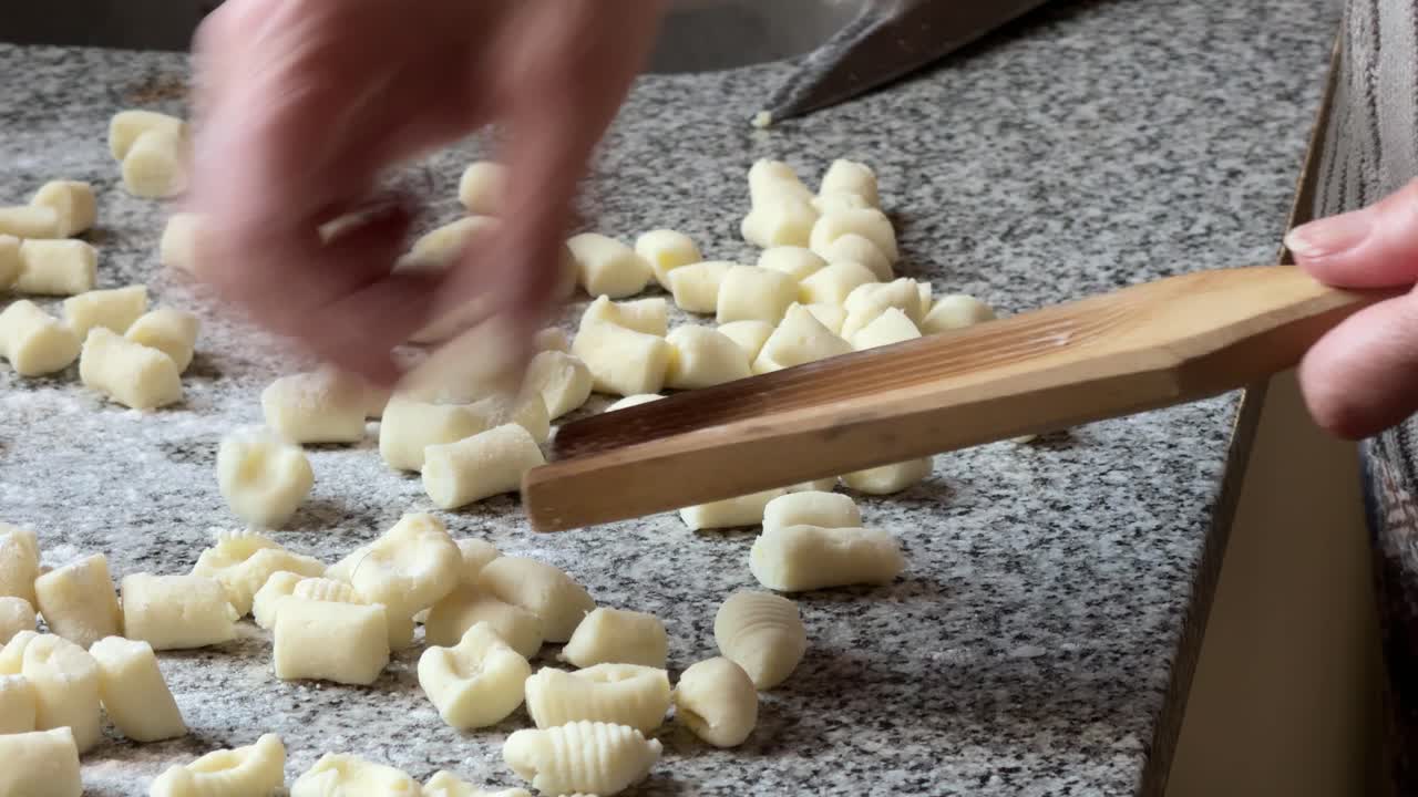Hands Ridging Gnocchi on a Gnocchi Board - Close Up