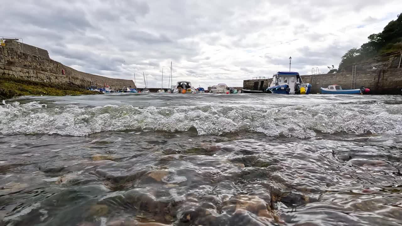 Waves crashing near a docked boat