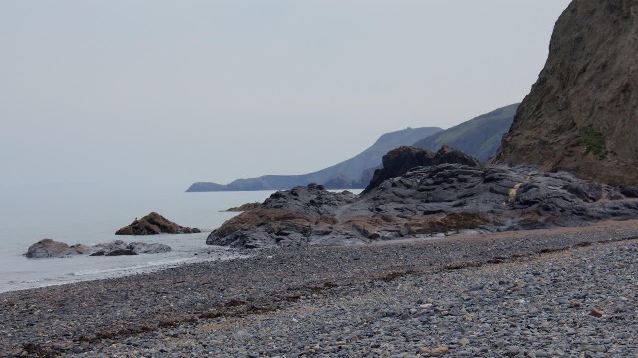 wide shot looking North east of exposed rocks at low tide at Tresaith beach