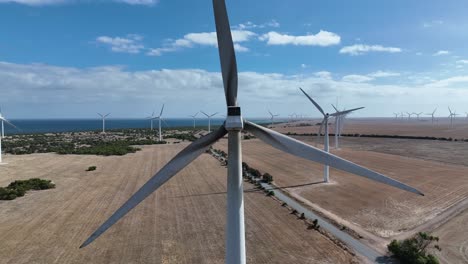 stationary drone shot of spinning wind turbine