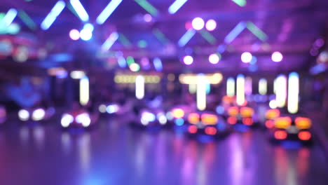 Bokeh-illuminated-blur-shot,showing-people-crashing-eachother-in-bumper-scooter-cars