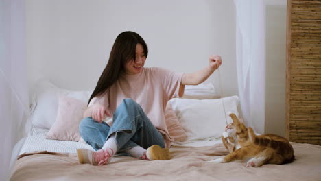 woman playing with cat