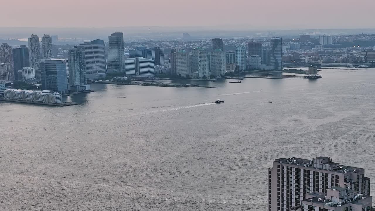Views of New York City skyline from a drone at sunset over the river