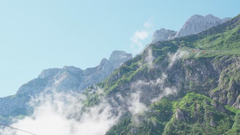 moving clouds in front of mountains