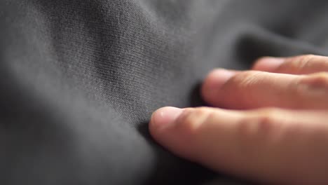 feeling the quality of black cotton fabric