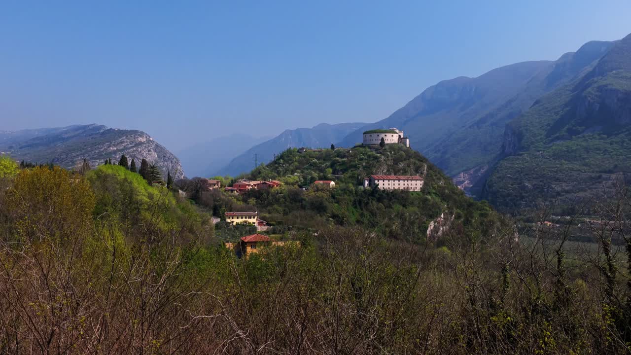 Rising aerial shot of Italian village and Fort Rivoli on picturesque hilltop, Italy