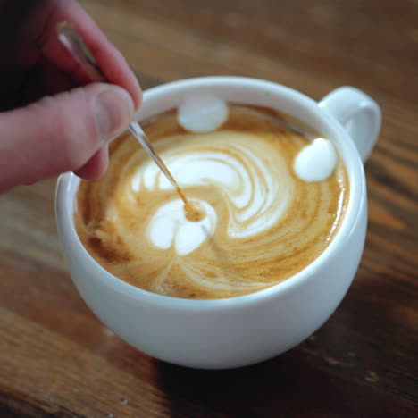 barista makes a drawing on coffee. art of making cappuccino in a cup. sqare video