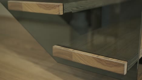 close-up of wooden staircase treads with glass paneling