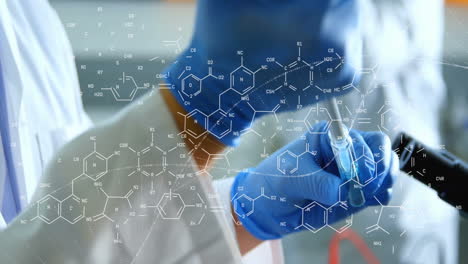 animation of dna strand and chemical formula over caucasian scientist doing experiment