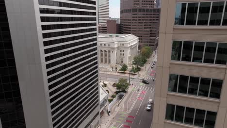 Light-traffic-in-city-centre-aerial-view-over-tall-office-building