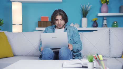 Funny-and-playful-young-man-uses-laptop-while-dancing.