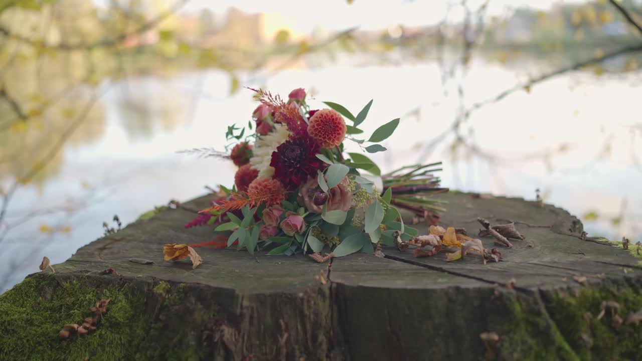 Autumn Wedding Bouquet on Tree Stump by the Lake