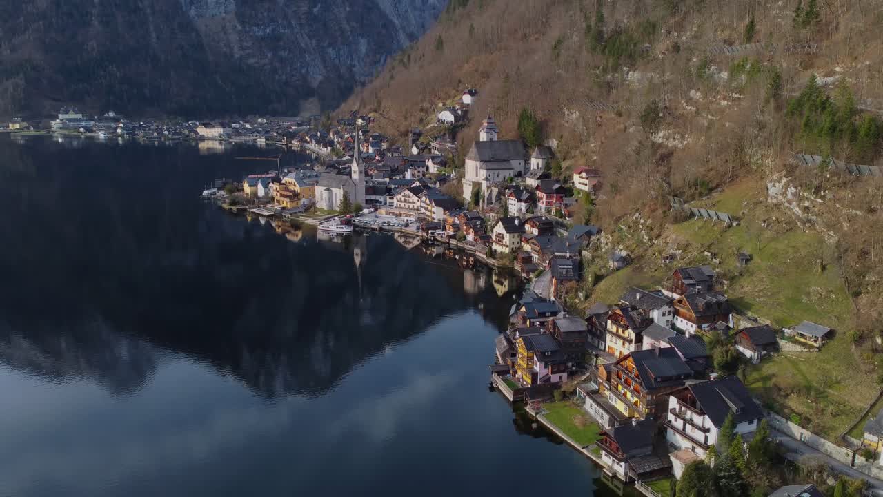 Hallstatt's iconic lakeside town from above with incredible reflections on Hallstätter See on an early and quiet Spring morning - Hallstatt, Austria