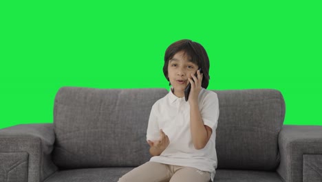 Indian-boy-talking-on-phone-Green-screen