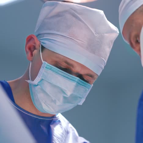portrait of a surgeon in medical mask at work. doctors' faces during the operating process in modern clinic. close-up.view from below.