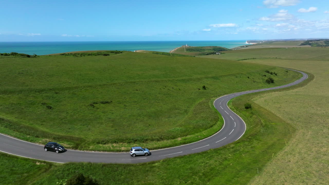Driving On The Road Along The Seven Sisters Cliffs On The English Channel Coast In East Sussex, England. Aerial Tracking Shot